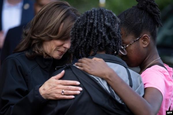 U.S. Vice President Kamala Harris, left, embraces community members as she surveys the damage from Hurricane Helene, in the Meadowbrook neighborhood of Augusta, Georgia, Oct. 2, 2024.