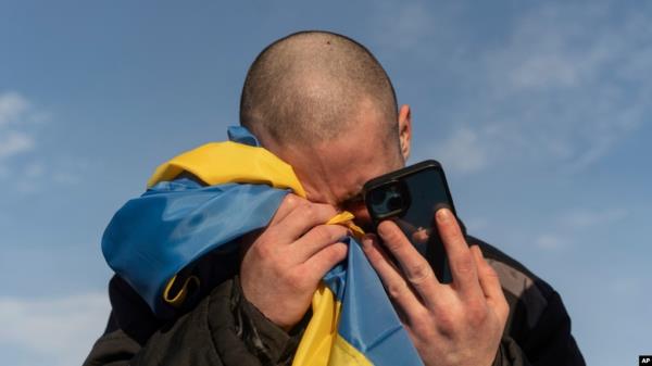 FILE - A recently swapped Ukrainian priso<em></em>ner of war cries while calling his relatives after a priso<em></em>ner exchange on the Ukraine-Russia border on Jan. 31, 2024. 