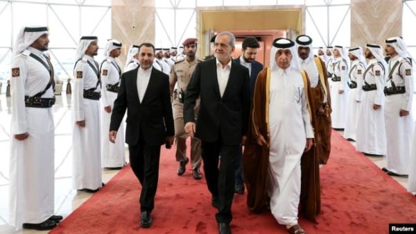 Iranian President Masoud Pezeshkian is welcomed by Qatari officials upon his arrival at Doha's airport, in Doha, Qatar, Oct. 2, 2024. (Iran's Presidency/WANA/Handout via Reuters)