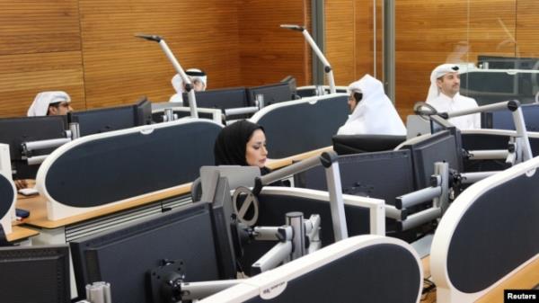 FILE - Qatari diplomats work inside an operation room set up to coordinate the truce and release of hostages between Israel and the Palestinian Islamist group Hamas, at the Natio<em></em>nal Command Centre in Doha, Nov. 26, 2023.