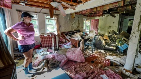 Cindy White looks over the devastation inside her home caused by Hurricane Helene in Morganton, North Carolina, Oct. 1, 2024. President Joe Biden will survey hurricane damage when he visits North Carolina on Wednesday.  