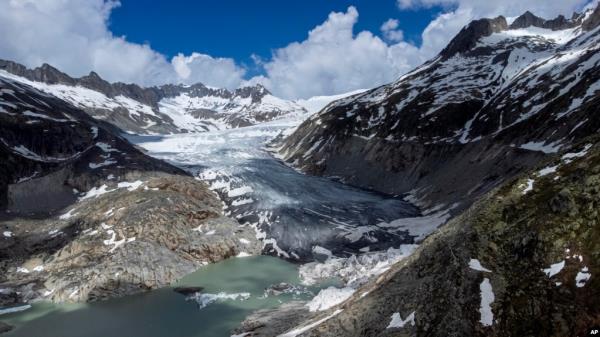 FILE - A lake of meltwater has formed on the to<em></em>ngue of the Rhone Glacier near Goms, Switzerland, June 13, 2023.