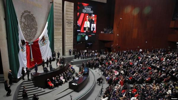 Mexico's President Claudia Sheinbaum speaks during her swearing-in ceremony at the Congress, in Mexico City, Mexico, Oct. 1, 2024. King Felipe VI of Spain was not invited to the event due, in part, to a dispute over Spain's 16th century defeat of Mexico's powerful Aztec rulers.