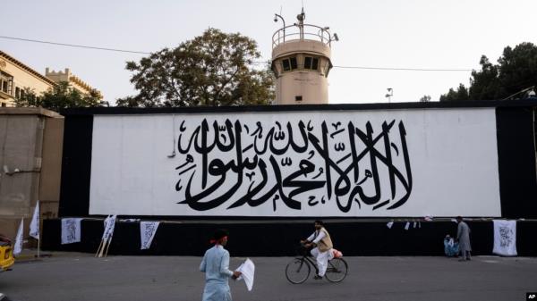 FILE - The ico<em></em>nic Taliban flag is painted on a wall outside the American embassy compound in Kabul, Afghanistan, Sept. 11, 2021. 