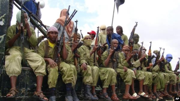 FILE - In this Oct. 30, 2009 file photo, al-Shabab fighters sit on a truck as they patrol in Mogadishu, Somalia.