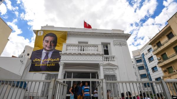 FILE - A poster of impriso<em></em>ned presidential candidate Ayachi Zammel is displayed at the entrance of his electoral headquarters on Sept. 16, 2024, in Tunis, ahead of presidential election. 