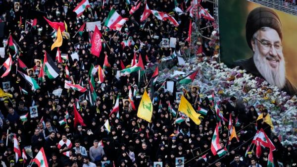 Mourners attend a rally commemorating slain Hezbollah leader Hassan Nasrallah, shown in billboard, at Felestin (Palestine) Square in downtown Tehran, Iran, Sept. 30, 2024. 