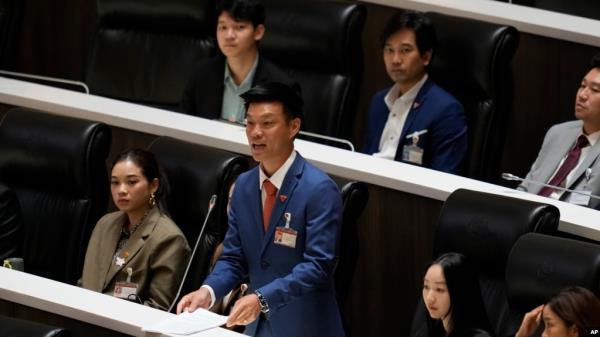 FILE - Leader of People's Party, Natthaphong Ruengpanyawut asks a question after Thailand's Prime Minister Paeto<em></em>ngtarn Shinawatra makes the policy statement at parliament in Bangkok, Sept. 12, 2024. 