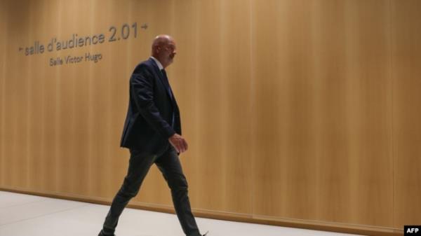 French politician and bodyguard Thierry Légier walks next to a courtroom at a court house on the starting day of a trial on suspicion of embezzlement of European public funds by members of the French far right party, in Paris, Sept. 30, 2024.