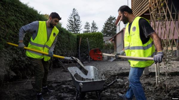 Migrants from the Free Syrian Community of Austria association volunteered to clean up after floods in Kritzendorf, Austria, Sept. 26, 2024.