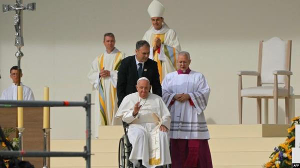 Pope Francis exits the stage on a wheelchair after a holy mass at King Baudouin stadium, in Brussels on Sept. 29, 2024. 