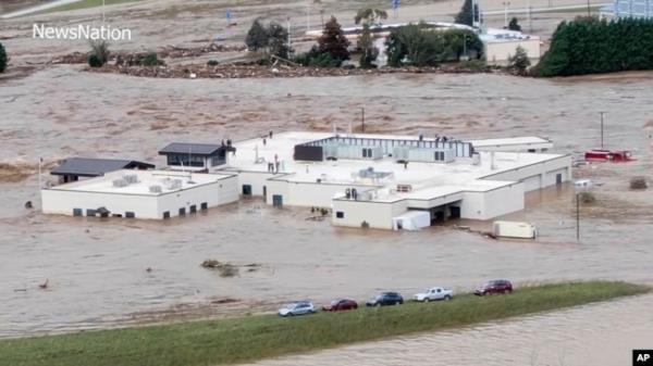 In this photo from video, people can be seen on the roof of the Unicoi County Hospital in Erwin, Tennessee, on Sept. 27, 2024. (NewsNation via AP)