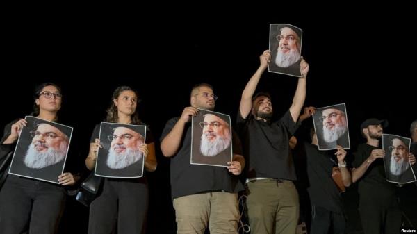 Supporters of Lebanon's Hezbollah leader Hassan Nasrallah carry his pictures as they gather in Sidon, Lebanon, on Sept. 28, 2024, following his killing in an Israeli airstrike in Beirut's southern suburbs the previous day.