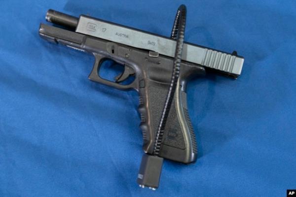 FILE - A Glock 17 pistol fitted a with a cable style gun lock in Philadelphia, May 10, 2023.