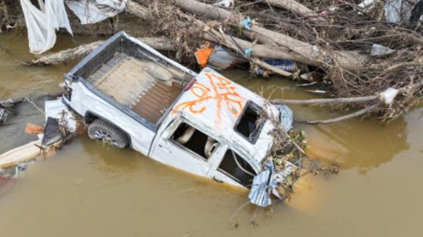 A drone view shows a pick-up truck partially submerged in the Swannanoa River near Biltmore Village, after Storm Helene hit the area, in Asheville, North Carolina, US October 5, 2024. Photo: REUTERS/Nathan Frandino