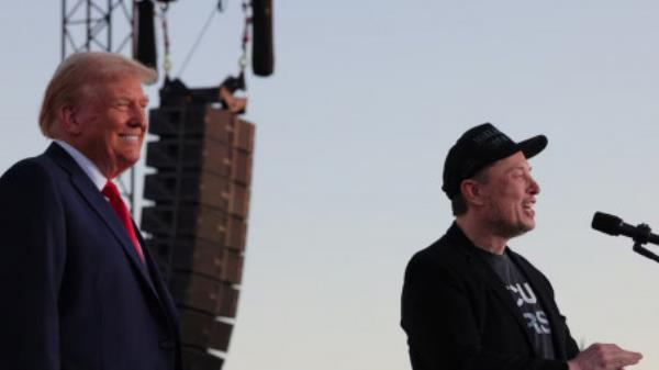 Tesla CEO and X owner Elon Musk speaks as Republican presidential nominee and former US president Do<em></em>nald Trump looks on during a campaign rally, at the site of the July assassination attempt against Trump, in Butler, Pennsylvania, US, October 5, 2024. Photo: REUTERS/Brian Snyder