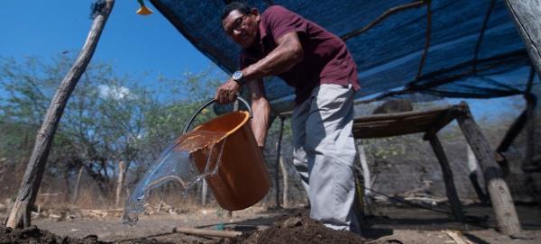 Manuel Mo<em></em>ntiel mixes some natural fertilizer made from goat manure in Ipasharrain village, Colombia.