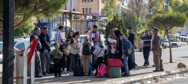 Families wait to cross the Masnaa border  from Lebanon into Syria. 