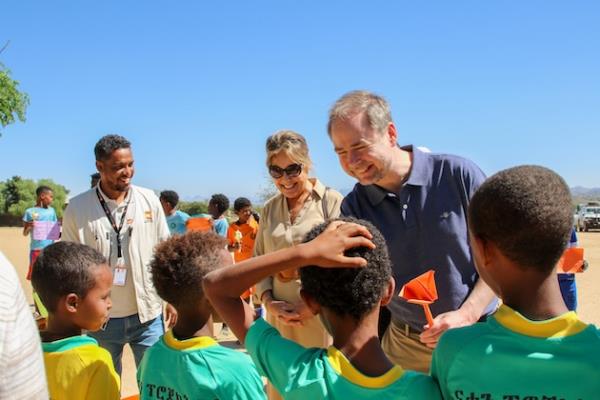 Yasmine Sherif, Executive Director, Education Cannot Wait (ECW) and Nicolai Wammen, ECW Global Champion and Danish Minister of Finance are welcomed by students at the ECW-supported Chila Primary School in Tigray, Ethiopia. Children here have missed more than three years of education due to COVID and the co<em></em>nflict that devastated the region. Photo credit: ECW