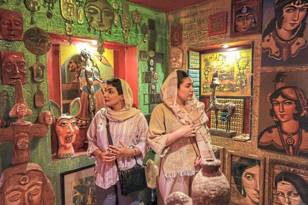 Visitors explore Adel’s workshop and studio, gaining a closer look at his intricate artworks. Photo: AFP 